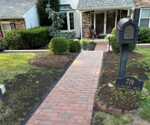 A newly restored residential walkway made out of pavers